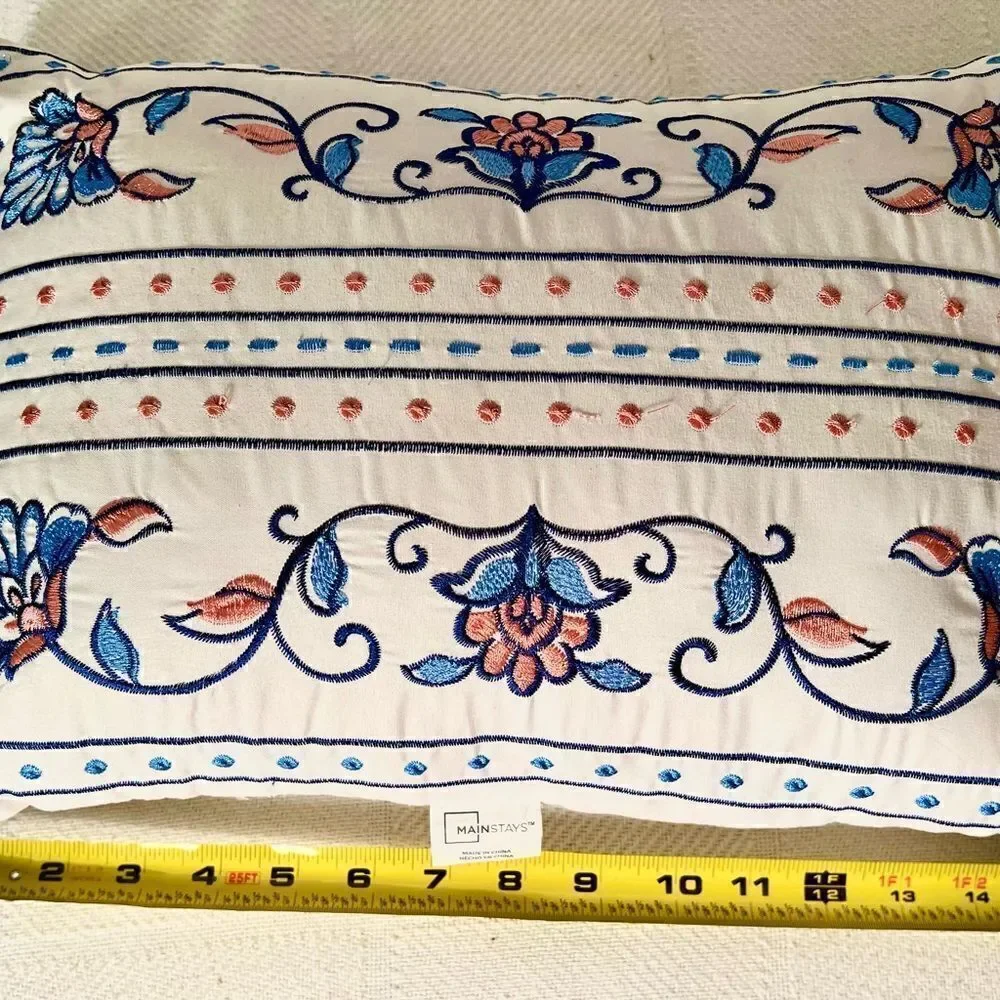 Mainstays Throw Pillow White w Blue/Pink Embroidery Approximately 16”x12”.